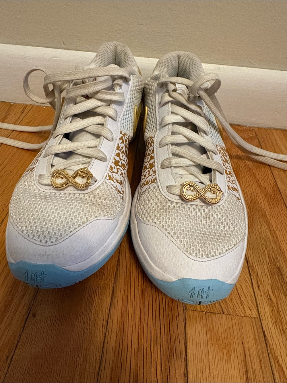 Nike Women White Sneakers with Gold Accents and Light Blue Soles